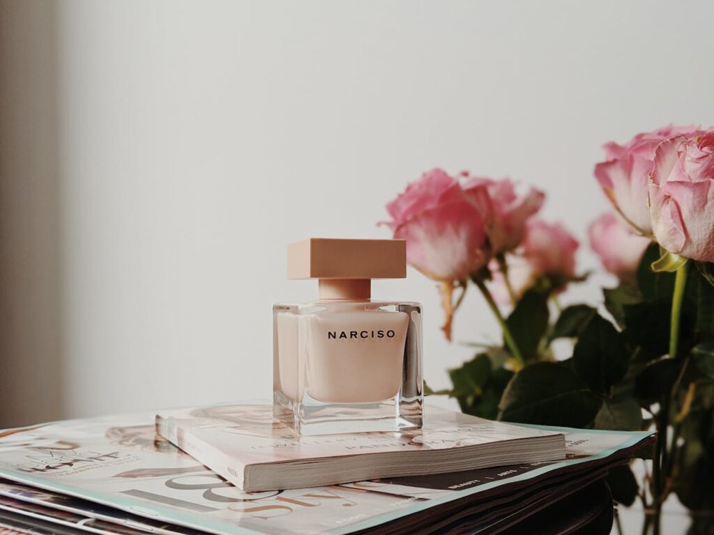 Crafting Captivating Headlines: Your awesome post title goes here Sophisticated Narciso perfume bottle with pink roses and magazines. Perfect for elegance and fragrance themes.