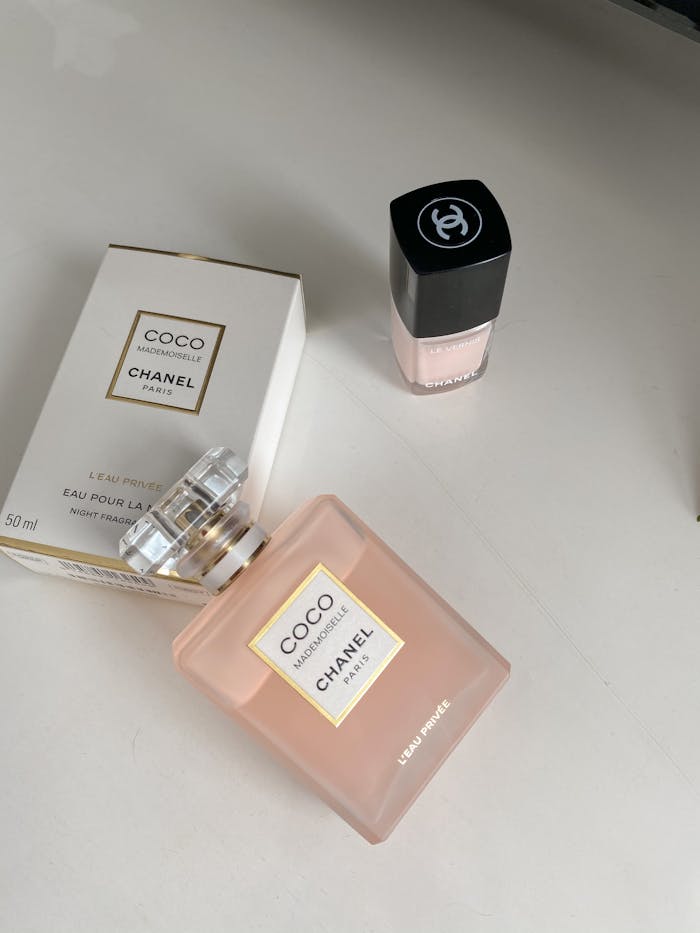 Mastering the First Impression: Your intriguing post title goes here Elegant product shot of Chanel Coco Mademoiselle perfume and nail polish on a white surface.